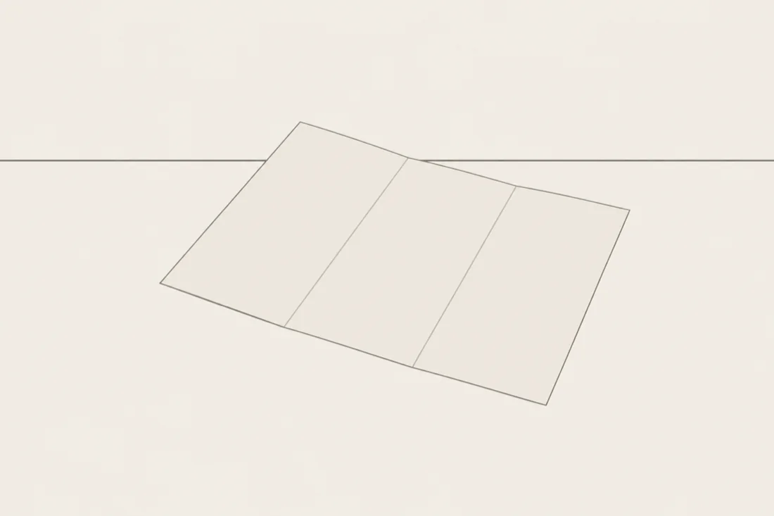 An illustration of a sheet of paper folded twice and lying flat, with nothing written on it.