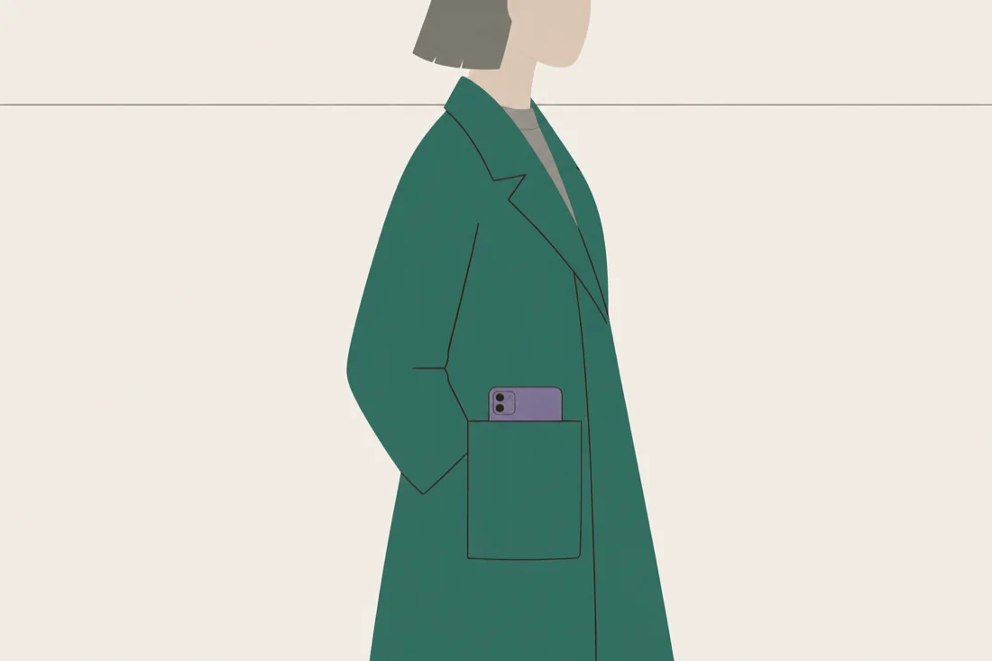 An illustration of the top of a phone protruding from a plain coat pocket.